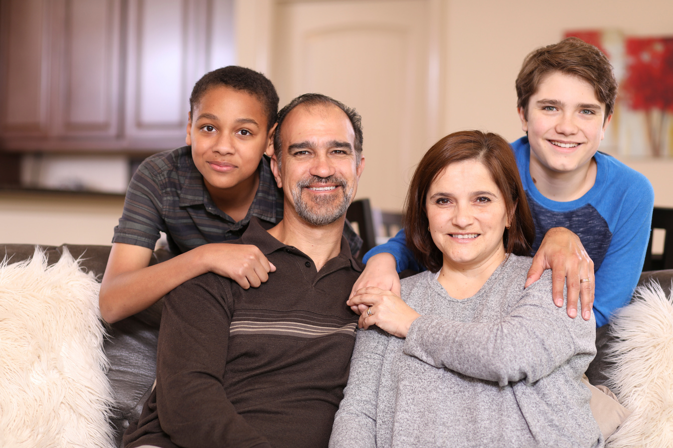 Multi-ethnic, adoption or foster care family at home.